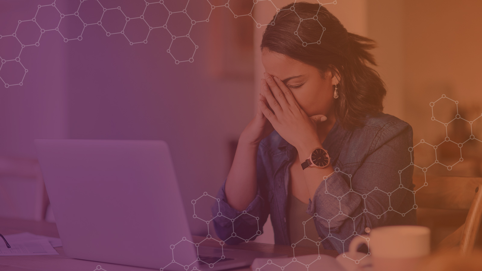 Stressed woman seated at desk