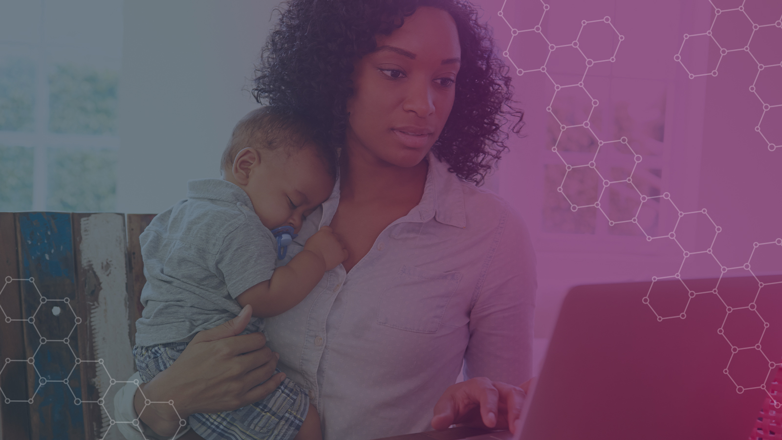 Woman working from home holding child