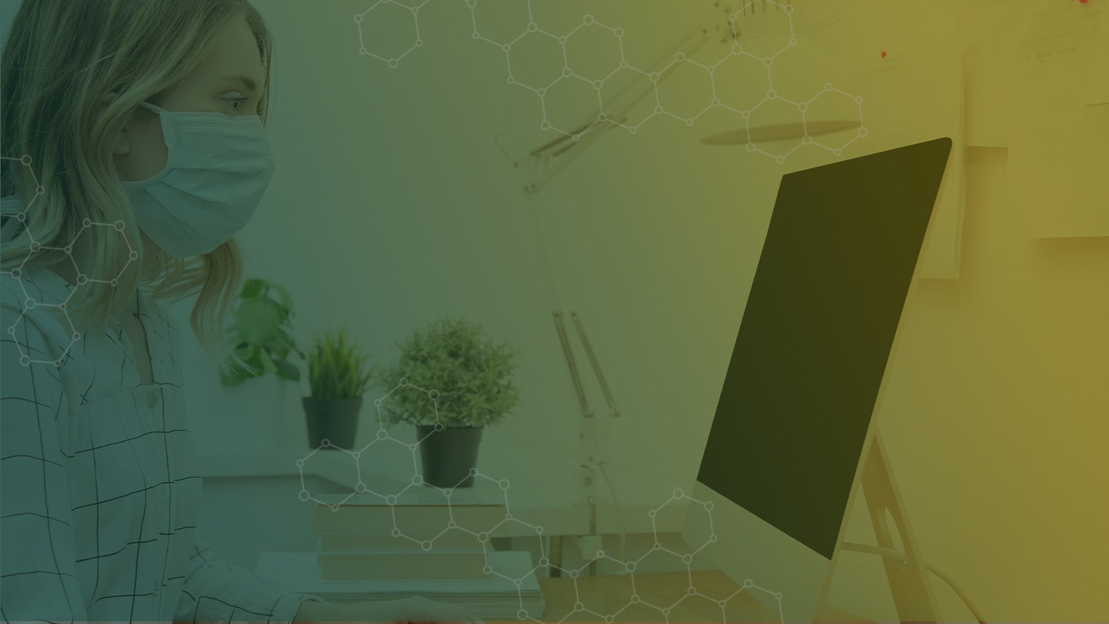 Woman at computer wearing mask