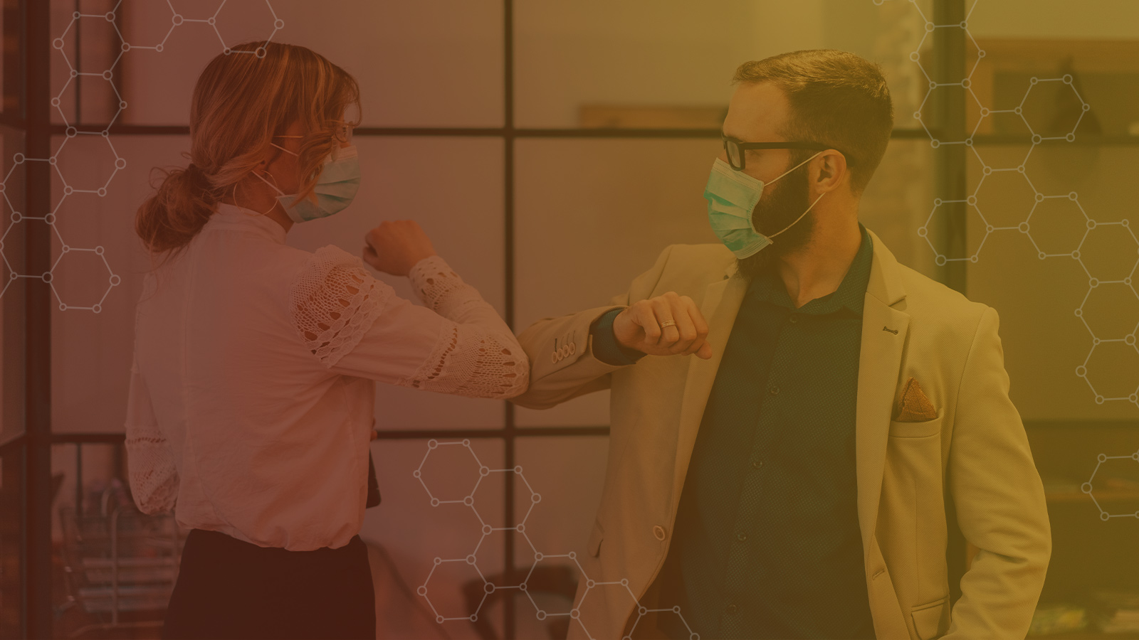 Two office workers bumping elbows