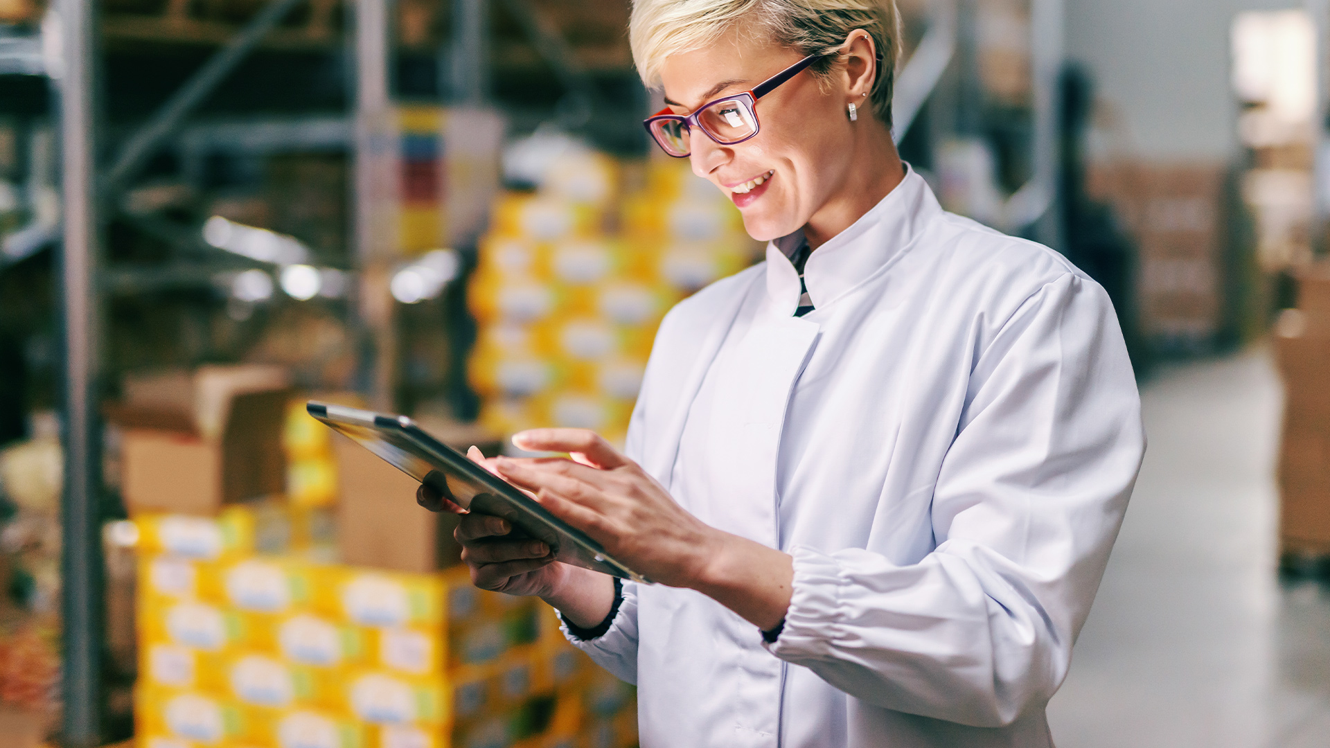 Woman checking a tablet in a warehouse