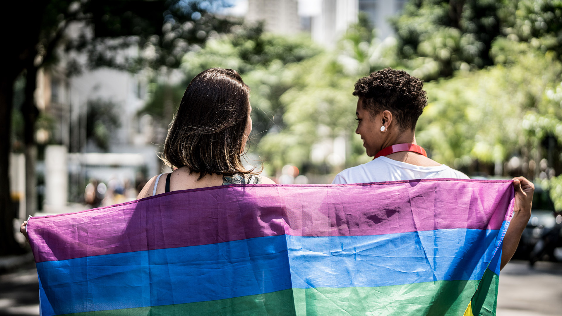 Two women holding a Pride flag
